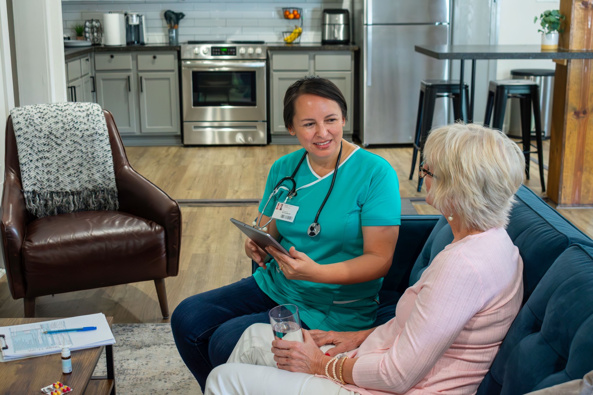 female home health nurse works with elderly patient