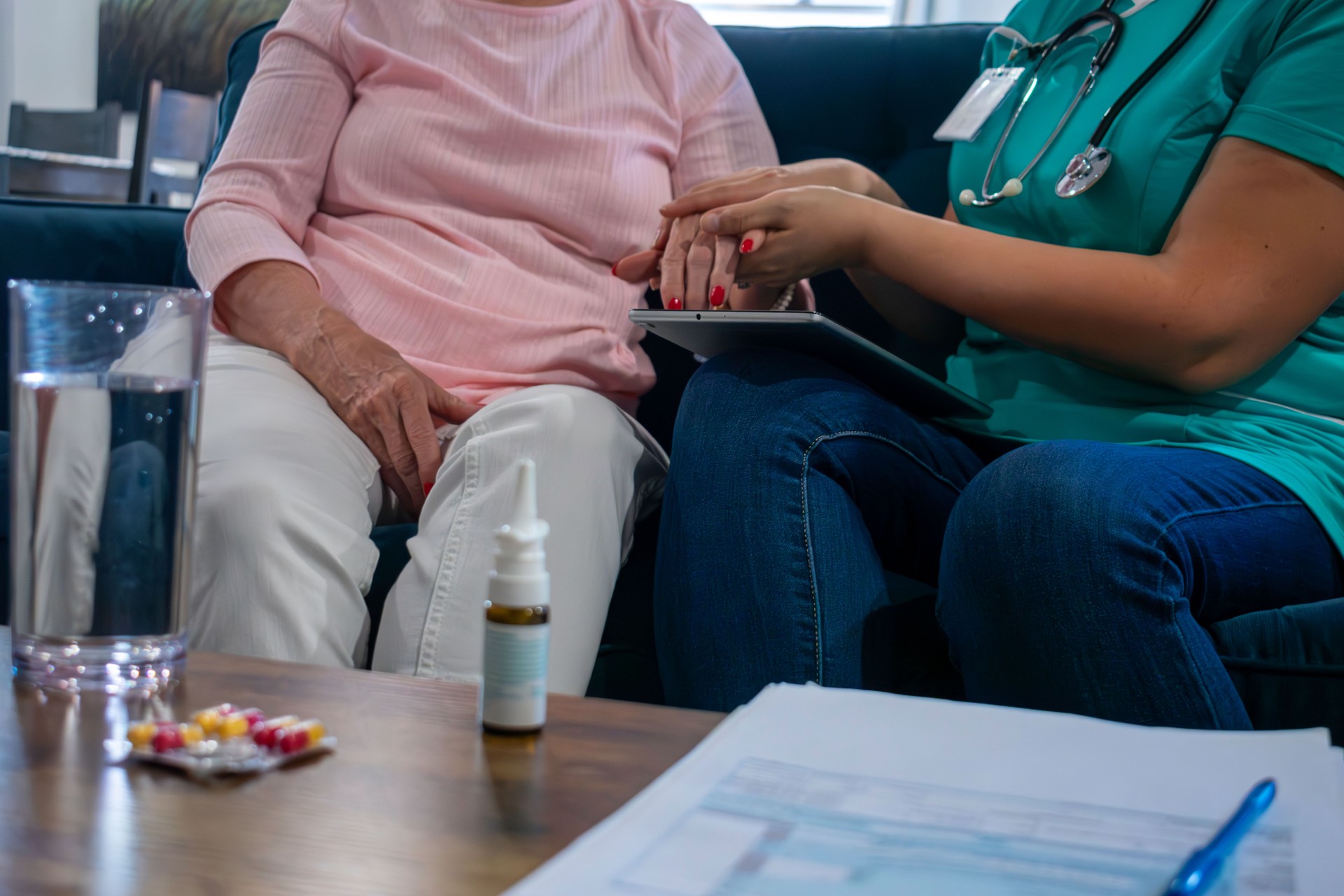 female home health nurse works with elderly patient