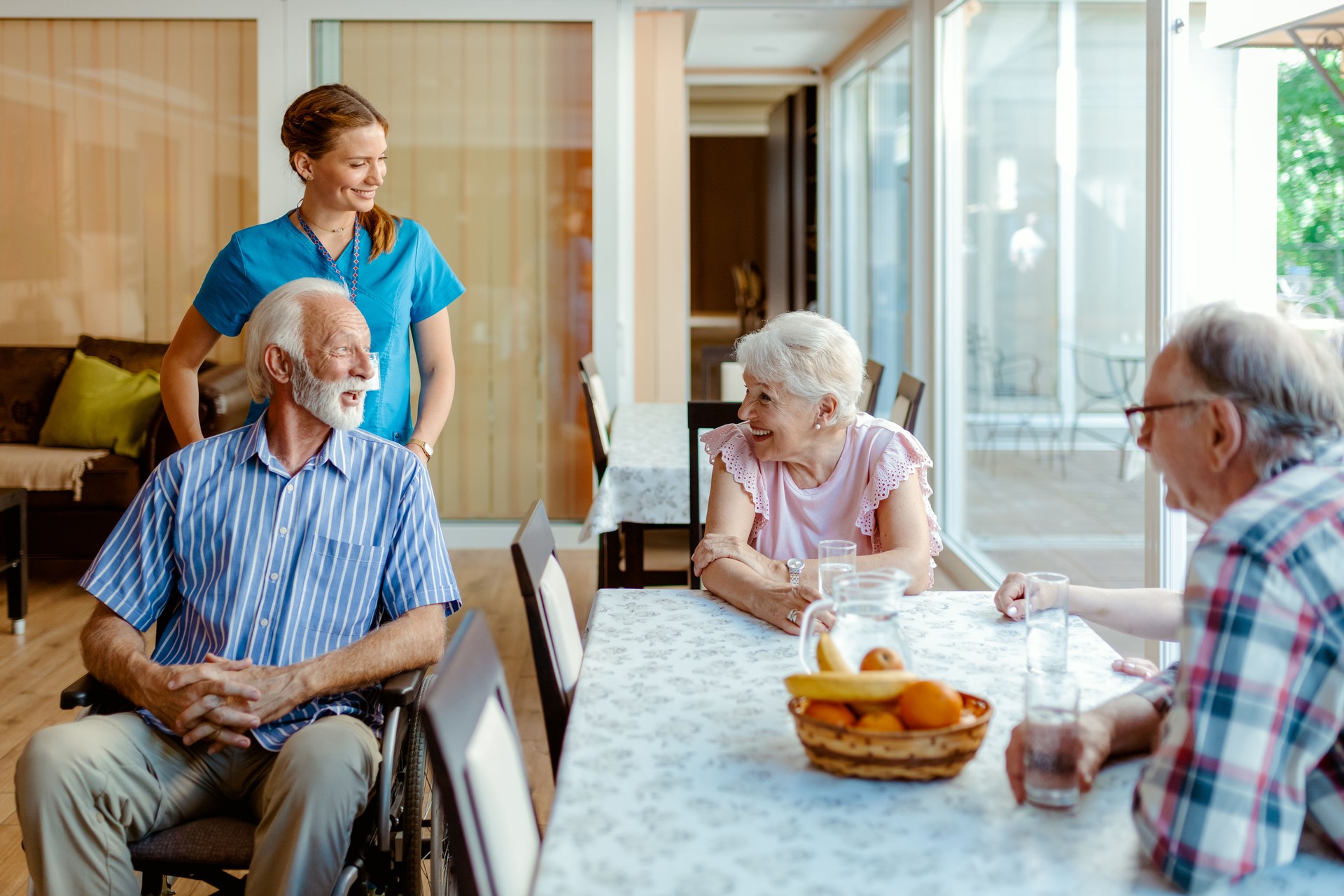 Senior People and Their Caregiver Talking in Living Room at Nursing Home